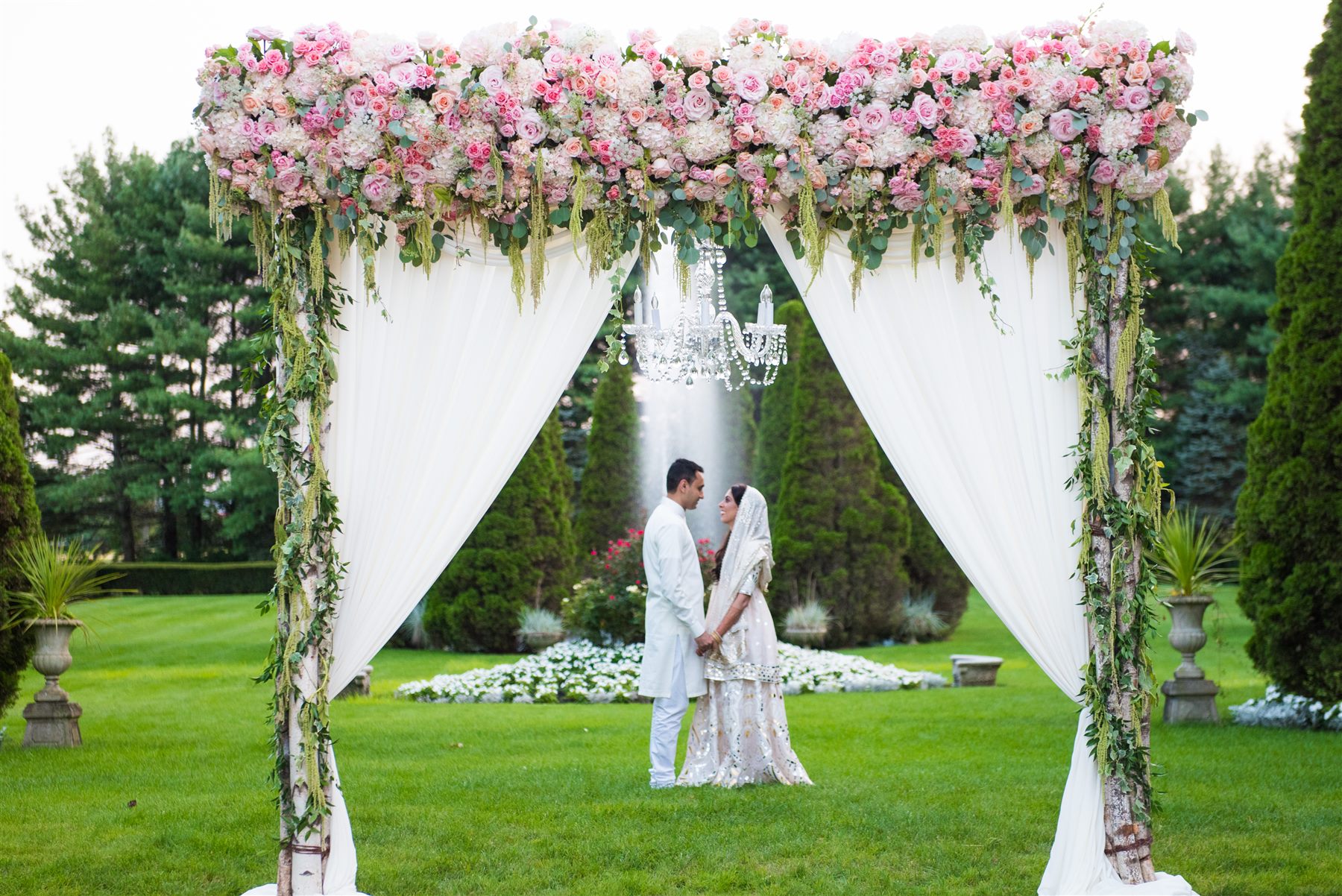 Blush mandap on the lawn of a private summer estate