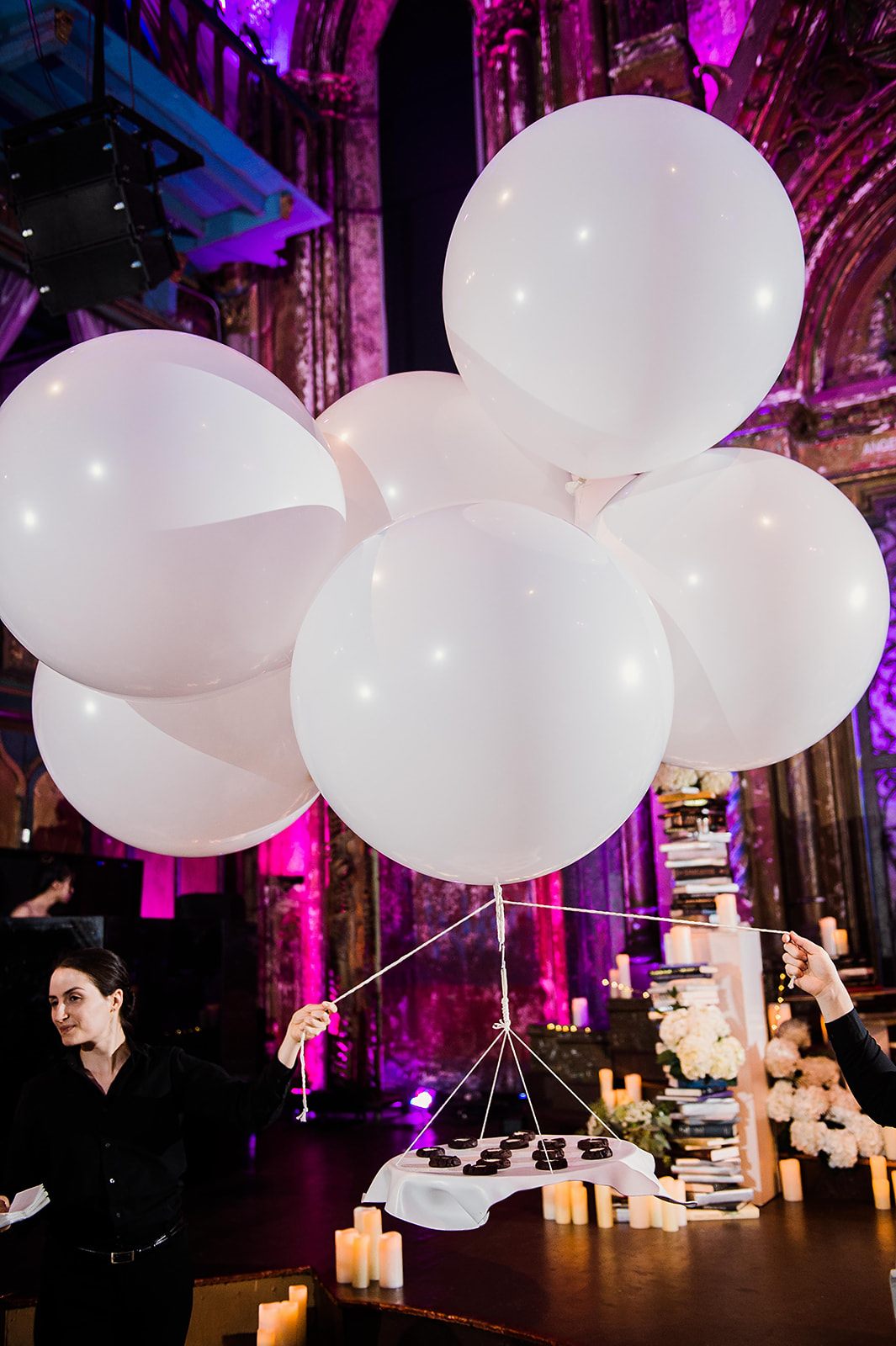 A cluster of white balloons, dessert beneath