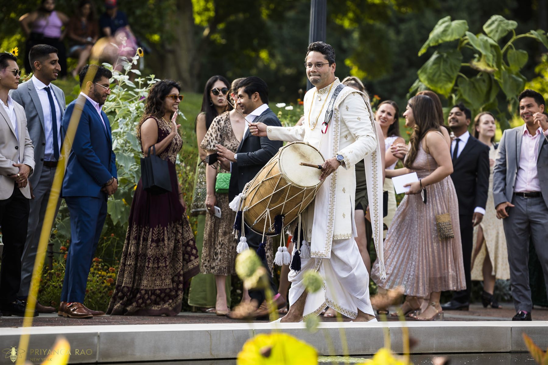 The baraat arrives along the lily pools
