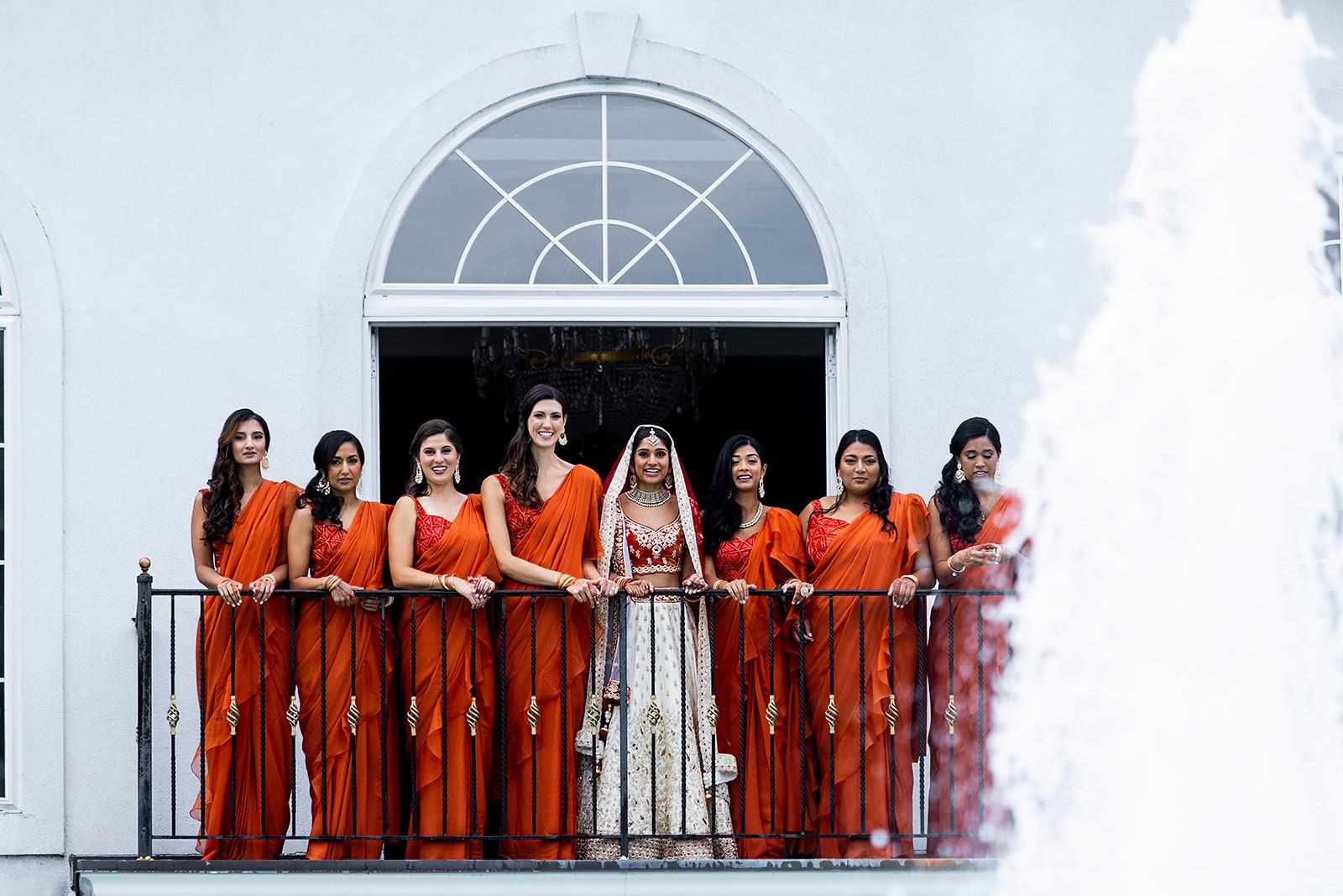 The bridal party on the balcony, the fountain below