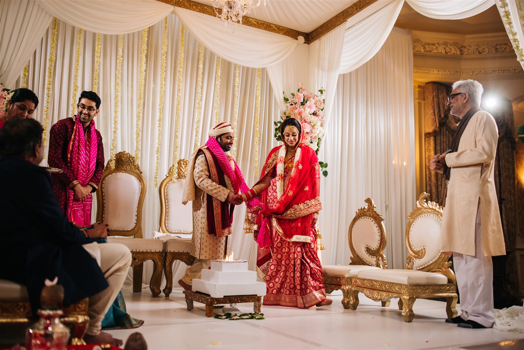 The mandap, dressed in blush and ivory, mid-ceremony