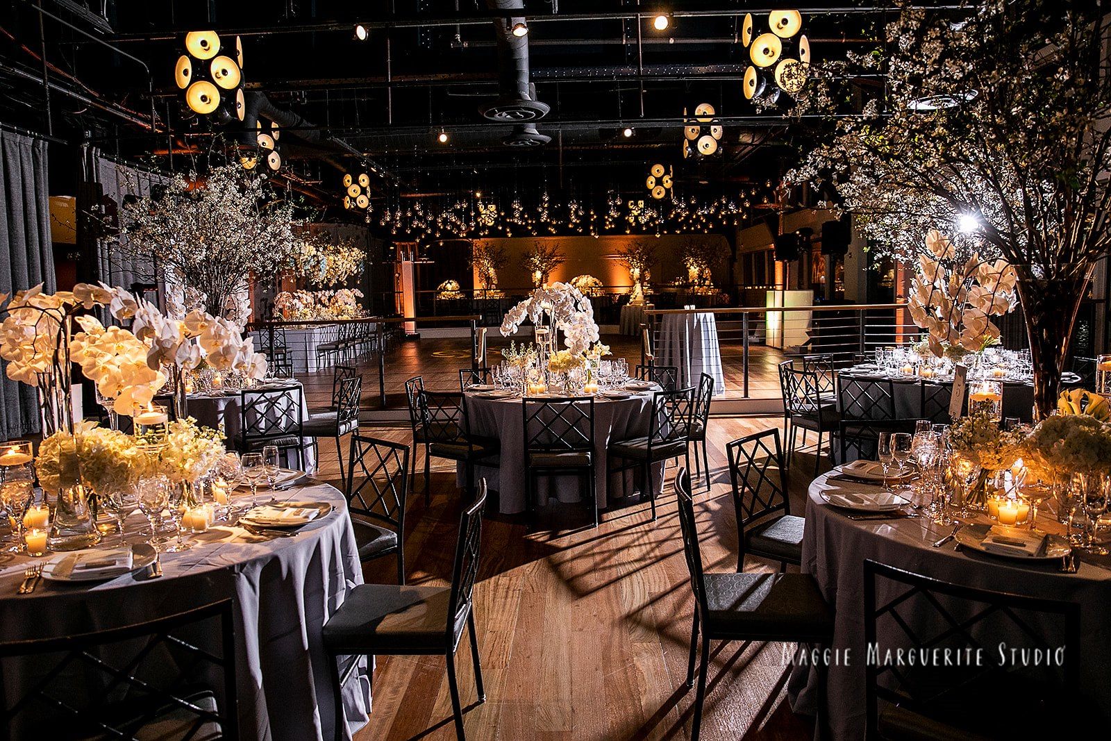 The reception beneath candlelit branches
